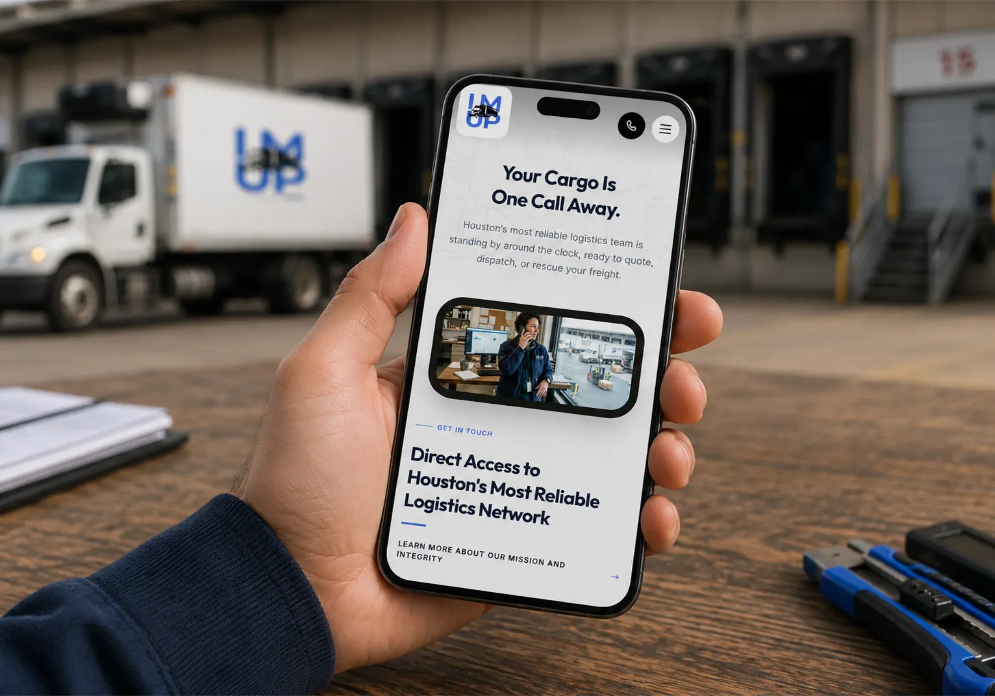 The IM UP Trucking website on a mobile phone, with the message that your cargo is one call away